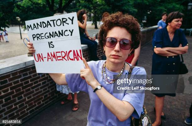 Portrait of an unidentified, pro-choice supporter at the annual anti-abortion March for Life, Washington DC, April 5, 1992. She holds a sign that...