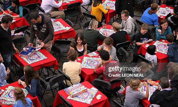 Players take part in a world-wide bid to set a new Guinness World Record for most people playing the board game "Monopoly" simultaneously, in Covent...