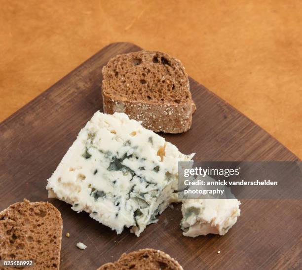 roquefort piece and cut baguette. - moldy bread stock pictures, royalty-free photos & images