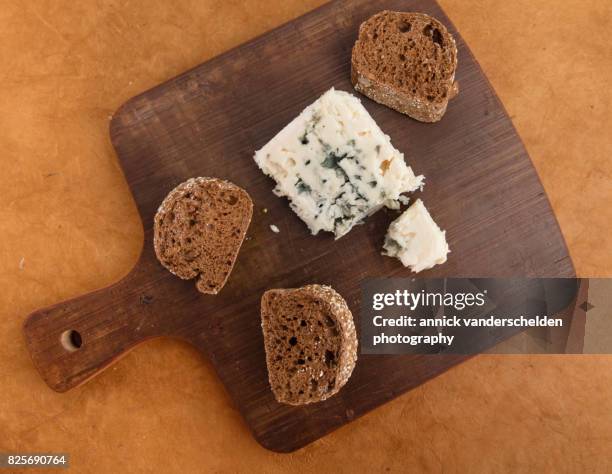 roquefort piece and cut baguette. - blue cheese crumble stock pictures, royalty-free photos & images