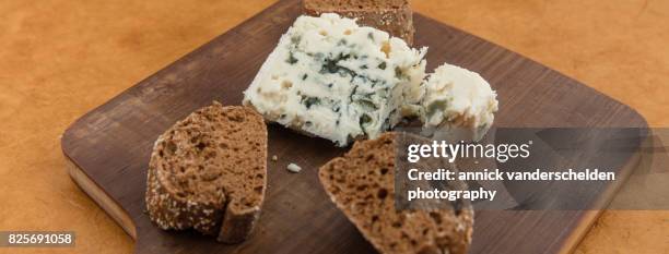 roquefort piece and cut baguette. - roquefort cheese ストックフォトと画像