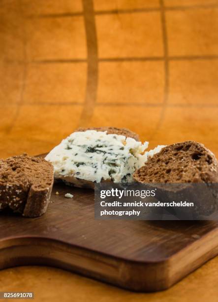 roquefort piece and cut baguette. - blue cheese crumble stock pictures, royalty-free photos & images