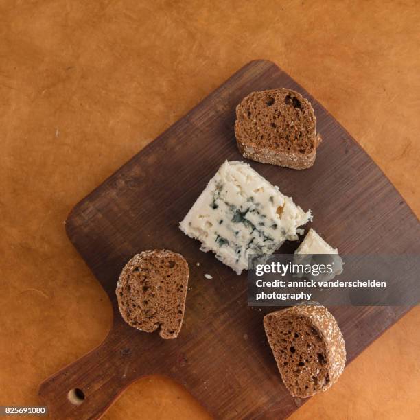 roquefort piece and cut baguette. - blue cheese crumble stock pictures, royalty-free photos & images