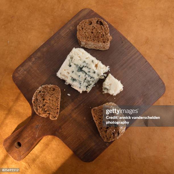 roquefort piece and cut baguette. - blue cheese crumble stock pictures, royalty-free photos & images