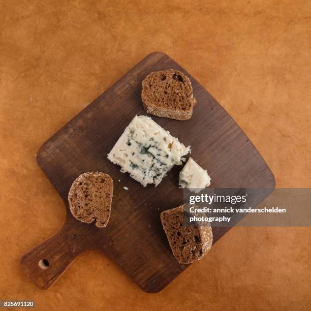 roquefort piece and cut baguette. - blue cheese crumble stock pictures, royalty-free photos & images