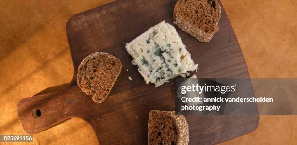 roquefort piece and cut baguette. - blue cheese crumble stock pictures, royalty-free photos & images