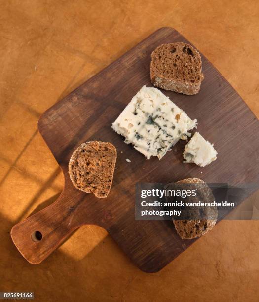 roquefort piece and cut baguette. - blue cheese crumble stock pictures, royalty-free photos & images