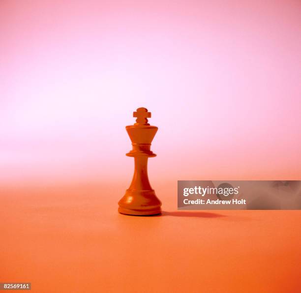 chess piece in colour background - king chess piece stock-fotos und bilder