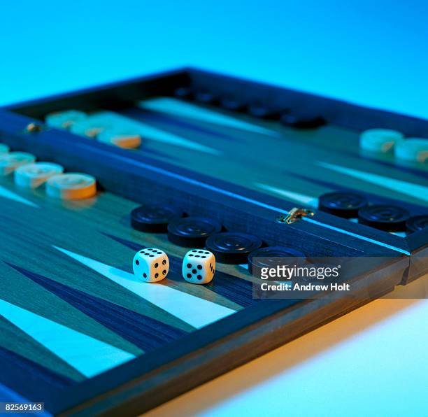 dice on backgammon board with blue background - backgammon ストックフォトと画像