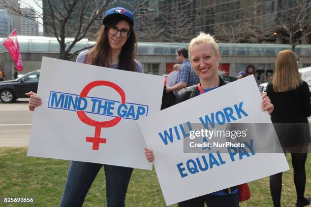 Women rally to demand equal pay for women and an end to the wage gap between the sexes on 'Equal Pay Day' in Toronto, Ontario, Canada, on April 11,...