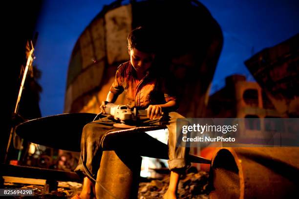 Boy works in a dockyard in the side of Buriganga River at Dhaka August 2, 2017. The laborers work in the dockyard without proper safety measures and...