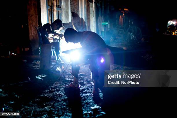 Boy works in a dockyard in the side of Buriganga River at Dhaka August 2, 2017. The laborers work in the dockyard without proper safety measures and...