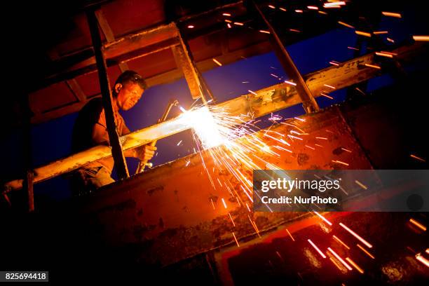 Bangladeshi labour works in a dockyard in the side of Buriganga River at Dhaka August 2, 2017. The laborers work in the dockyard without proper...