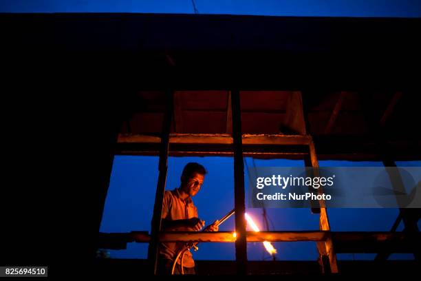 Bangladeshi labour works in a dockyard in the side of Buriganga River at Dhaka August 2, 2017. The laborers work in the dockyard without proper...