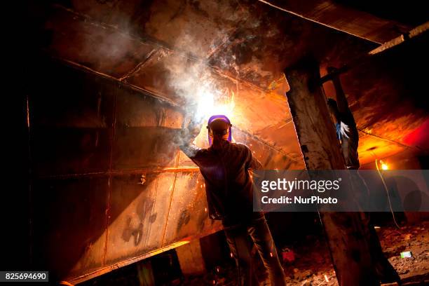 Labour welding in a dockyard in the side of Buriganga River at Dhaka August 2, 2017. The laborers work in the dockyard without proper safety measures...