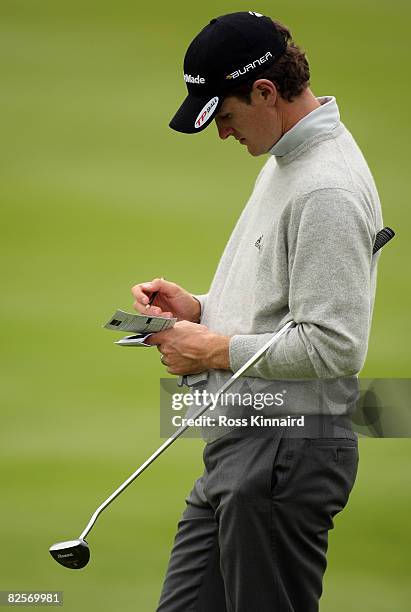 Justin Rose of England writes down his score during the pro-am event prior to The Johnnie Walker Championship at Gleneagles on August 27, 2008 at the...