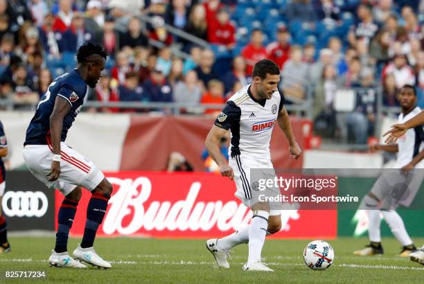 Philadelphia Union midfielder Chris Pontius moves away from New England Revolution midfielder Gershon Koffie during an MLS match between the New...