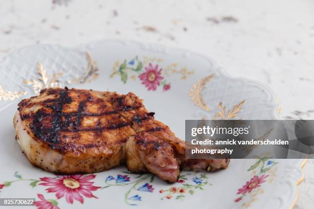 grilled pork chop on decorative plate. - pig back stock pictures, royalty-free photos & images