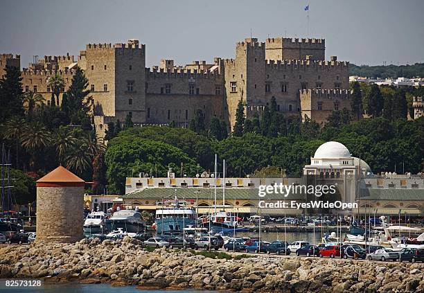 Mandraki Harbour is seen with the old town and the Palace of the Grand Masters on July 21, 2008 in Rhodes, Greece. Rhodes is the largest of the Greek...