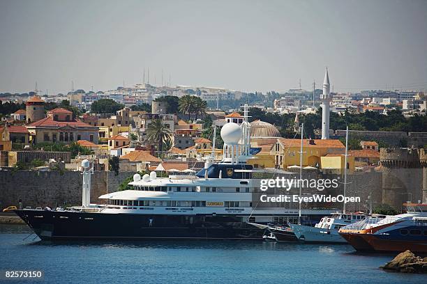 Luxury yacht in Mandraki Harbour is seen with the old town and parts of the Palace of the Grand Masters on July 20, 2008 in Rhodes, Greece. Rhodes is...