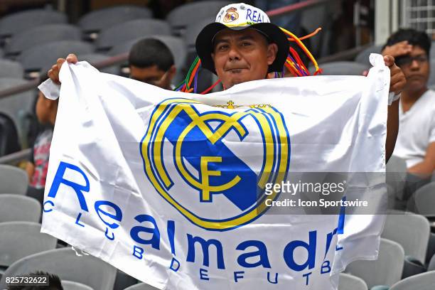 Real Madrid fan holds up his team's flag prior to a soccer match between the MLS All-Stars and Real Madrid on August 2 at Soldier Field, in Chicago,...
