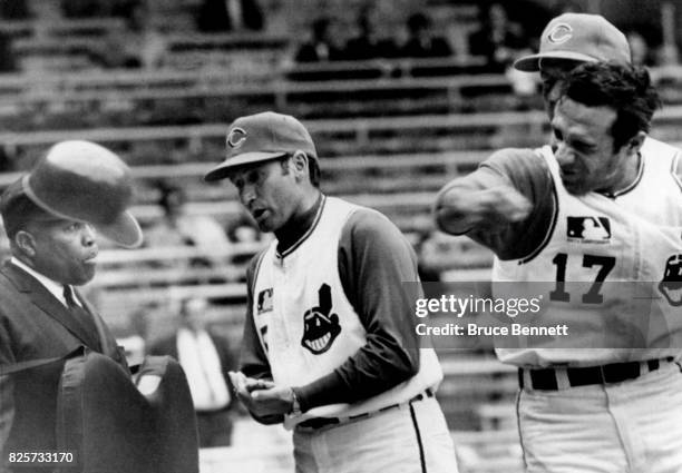 Zolio Versalles of the Cleveland Indians punches his helmet in anger after being called out on strikes by umpire Emmett Ashford as manager Alvin Dark...