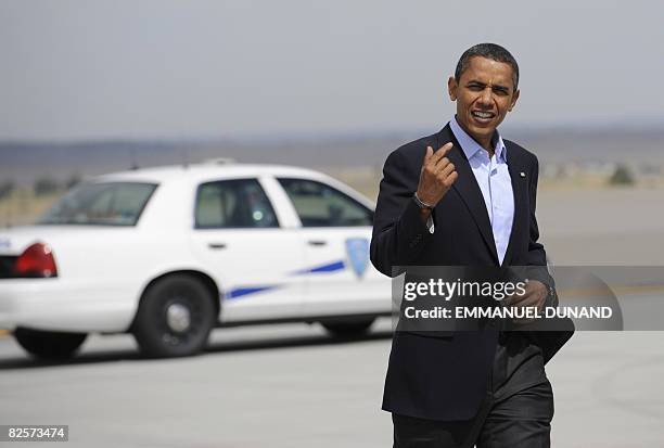 Democratic presidential candidate Illinois Senator Barack Obama makes his way to his campaign plane on the way to Denver, Colorado, to attend the...