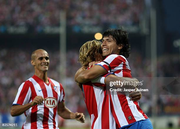 Aguero of Atletico Madrid celebrates his opening goal with his teammates Diego Forlan and Mariano Pernia during the UEFA Champions League third...