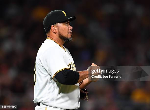 Joaquin Benoit of the Pittsburgh Pirates reacts after giving up a solo home run to Jesse Winker of the Cincinnati Reds during the seventh inning...