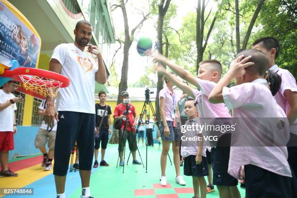 Player Tony Parker plays game with kids at a rehabilitation center for disabled children on August 2, 2017 in Guilin, Guangxi Zhuang Autonomous...