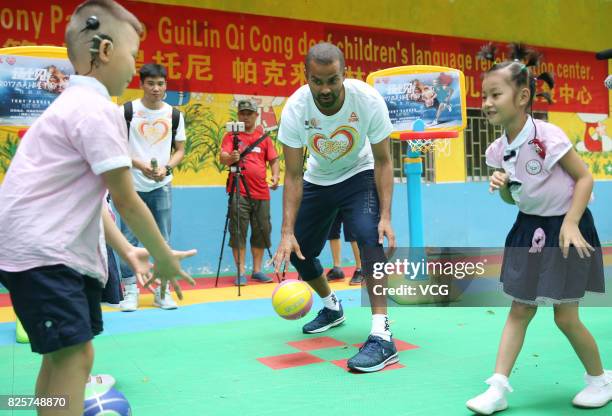 Player Tony Parker plays game with kids at a rehabilitation center for disabled children on August 2, 2017 in Guilin, Guangxi Zhuang Autonomous...