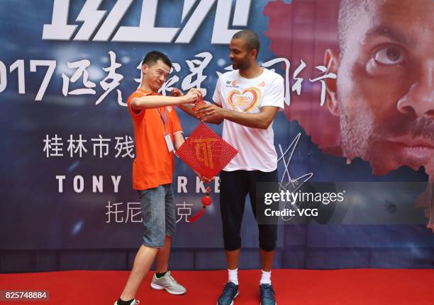 Player Tony Parker visits a rehabilitation center for disabled children on August 2, 2017 in Guilin, Guangxi Zhuang Autonomous Region of China.