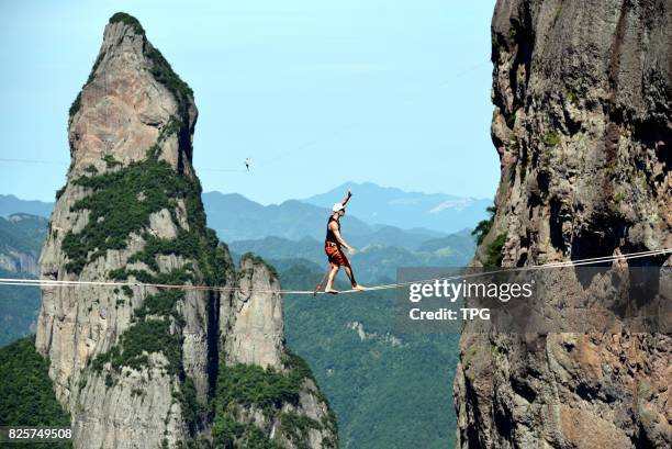 Breath-taking slacklining competition is held in Shenxianju scenic spot in Taizhou City, east Chinas Zhejiang Province, July 16, 2017. More than 30...