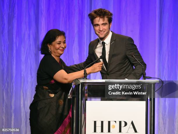 President Meher Tatna and Robert Pattinson speak onstage at the Hollywood Foreign Press Association's Grants Banquet at the Beverly Wilshire Four...