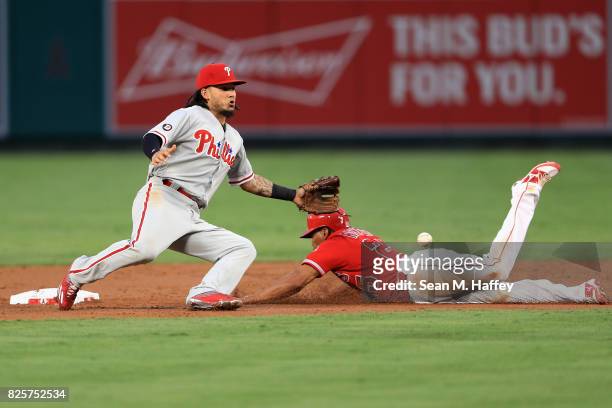 Ben Revere of the Los Angeles Angels of Anaheim safely steals second base as Freddy Galvis of the Philadelphia Phillies mishandles the throw during...