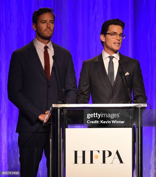Armie Hammer and Matt Bomer speak onstage at the Hollywood Foreign Press Association's Grants Banquet at the Beverly Wilshire Four Seasons Hotel on...