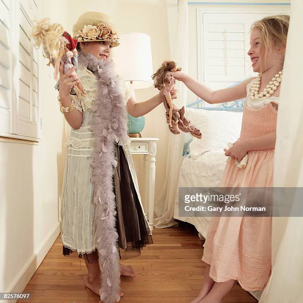 two girls dressed up in adult fancy clothes  - barbie foto e immagini stock