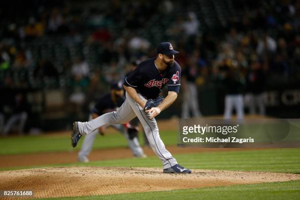 Boone Logan of the Cleveland Indians pitches during the game against the Oakland Athletics at the Oakland Alameda Coliseum on July 14, 2017 in...