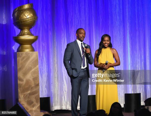 Anthony Mackie and Aja Naomi King speak onstage at the Hollywood Foreign Press Association's Grants Banquet at the Beverly Wilshire Four Seasons...