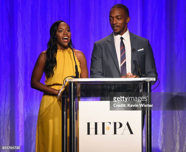 Aja Naomi King and Anthony Mackie speak onstage at the Hollywood Foreign Press Association's Grants Banquet at the Beverly Wilshire Four Seasons...