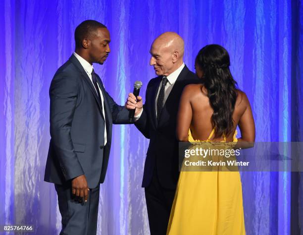 Anthony Mackie, Sir Patrick Stewart and Aja Naomi King speak onstage at the Hollywood Foreign Press Association's Grants Banquet at the Beverly...