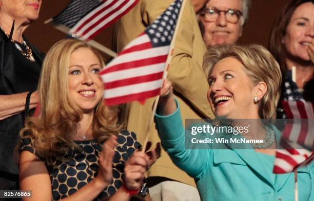 Sen. Hillary Clinton and Chelsea Clinton wave flags during former U.S. President Bill Clinton speech on day three of the Democratic National...