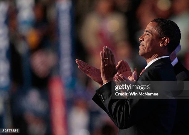 Sen. Barack Obama claps during a surprise appearance on day three of the Democratic National Convention at the Pepsi Center August 27, 2008 in...