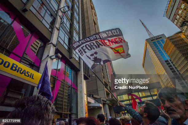 Demonstrators protest at Paulista Avenue in Sao Paulo, Brazil, as they watch a screen showing lawmakers voting in Brasilia on whether to put...