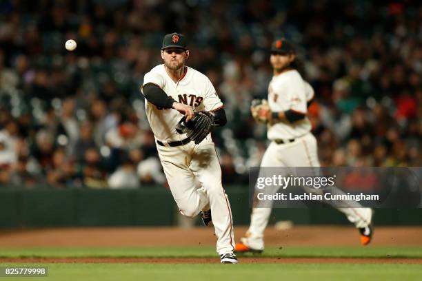 Conor Gillaspie of the San Francisco Giants throws to first base to get the out of Matt Chapman of the Oakland Athletics in an interleague game at...