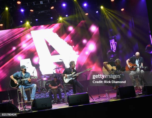 Singer/Songwriter Jason Aldean, Guitarist Tully Kennedy, Singer/Songwriters Wendell Mobley and Jerry Flowers perform during Jason Aldean's Triple...