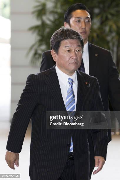 Toshimitsu Motegi, newly-appointed economic revitalization minster of Japan, left, arrives at the Prime Minister's official residence in Tokyo,...