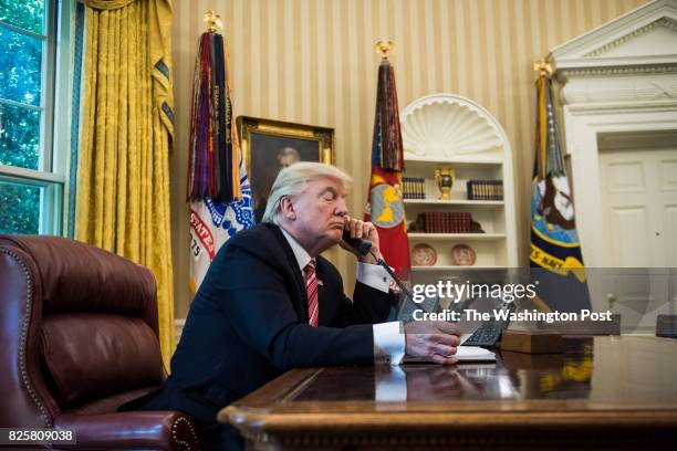 President Donald Trump talks with new Irish Prime Minister Leo Varadkar during a telephone call in the Oval Office of the White House of the White...