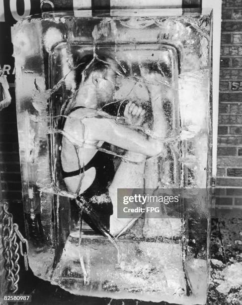 An escape artist encased in a block of ice, circa 1930.