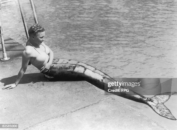 Mermaid sitting by a pool's edge in Scotland, 1949.